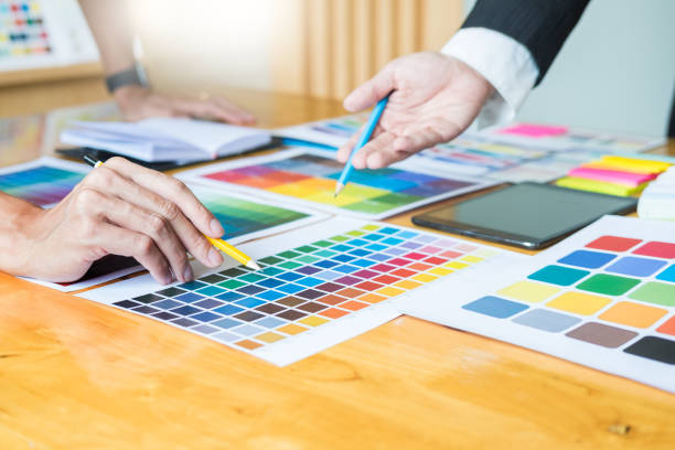 istock Midsection Of Creative Occupation People Discussing Over Color Swatch On Table At Office 1095173476