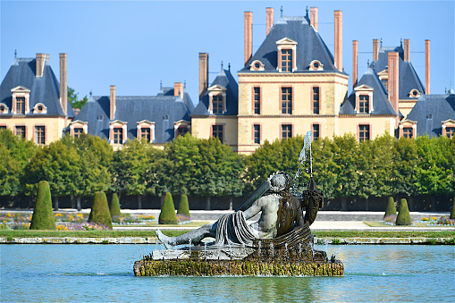 Greek style fountain in the the French formal garden of the Palace of Fontainebleau, located southeast of the center of Paris,which is one of the largest French royal châteaux, and now a national museum and a UNESCO World Heritage Site.