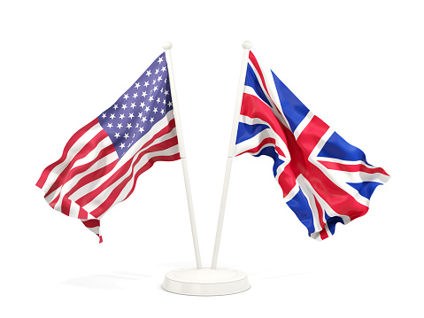 Two waving flags of United States and UK isolated on white. 3D illustration