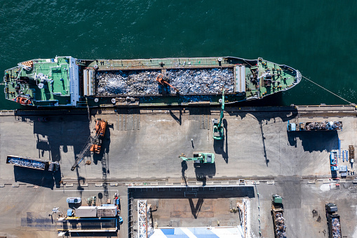 Cebu City, Philippines - May 2022: A Roro open deck cargo ship laden with freight trucks passes through the Port of Cebu.