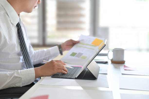 istock Businessman analyzing financial statistics displayed on the tablet screen. 1095178930