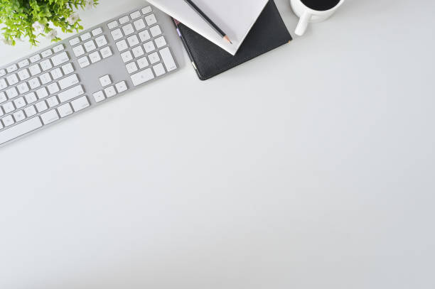 istock Flat lay top view office desk. Workspace with keyboard and office supplies with coffee on white background. 1095180732