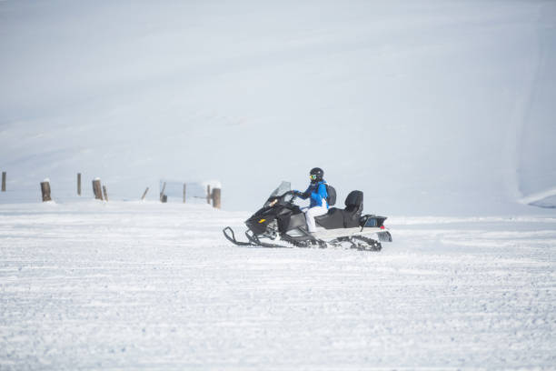 istock Woman driving snowmobile 1095192222