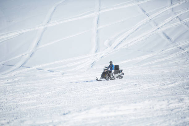 istock Woman driving snowmobile 1095192228