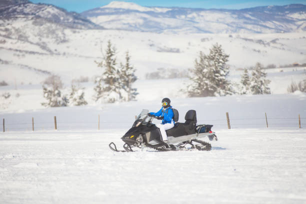 istock Woman driving snowmobile 1095192244