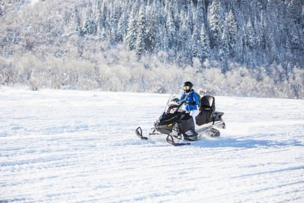istock Woman driving snowmobile 1095192254