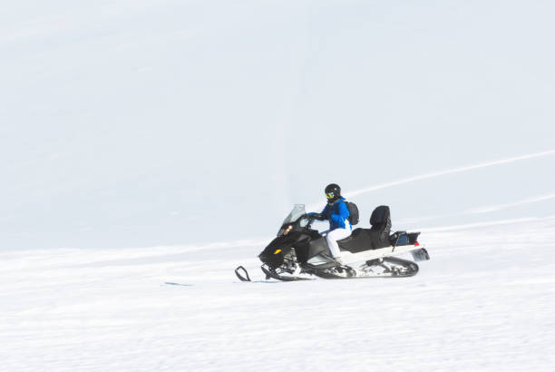 istock Woman driving snowmobile 1095192262