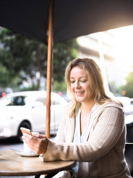 istock Woman sitting outside at a table at a sidewalk cafe 1095193830