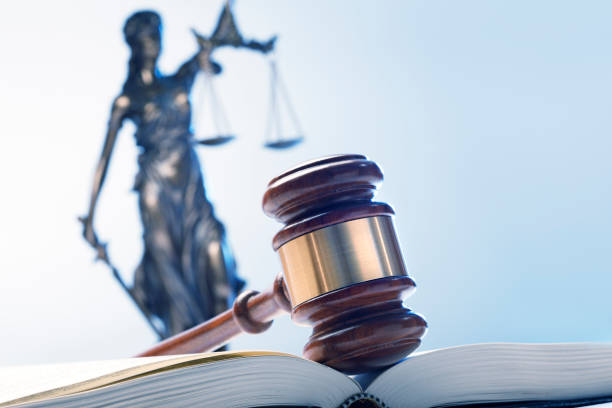 istock Gavel On Open Law Book With Lady Justice In The Background 1095196254