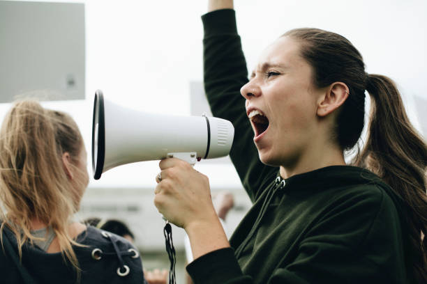 istock Female activist shouting on a megaphone 1095199358