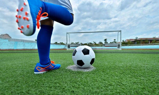istock Young boy feet kicking a soccer ball 1095227174