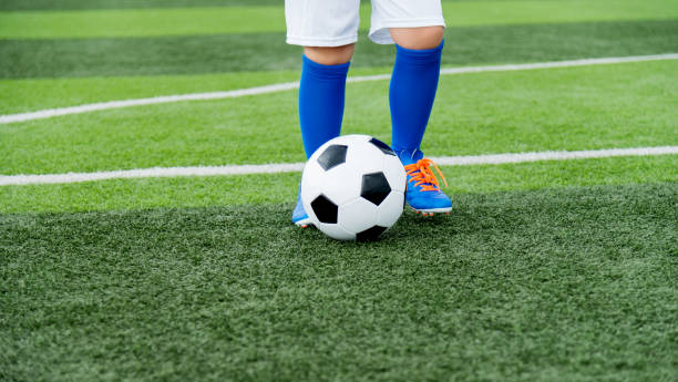 istock Young boy running after a soccer ball 1095227188