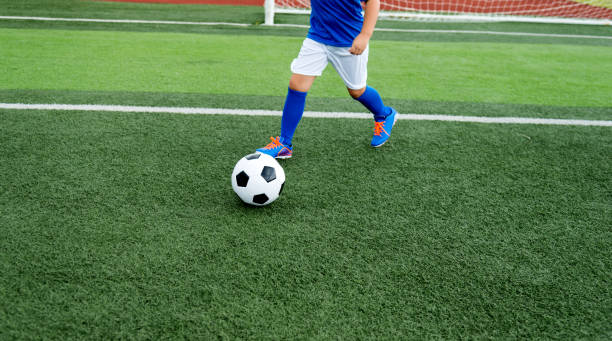 istock Young boy running after a soccer ball 1095227190