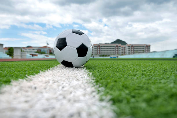 istock Soccer ball on white line 1095227296