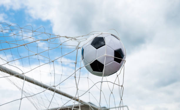 istock Soccer ball hitting the net 1095227396
