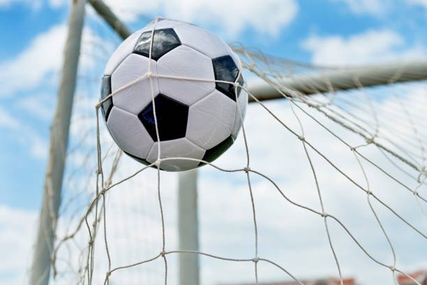 istock Soccer ball hitting the net 1095227402
