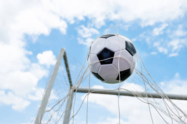 istock Soccer ball hitting the net 1095227410
