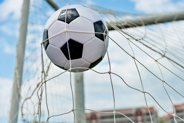 istock Soccer ball hitting the net 1095227418