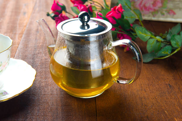 istock Cup with green tea on grey wooden background 1095229184