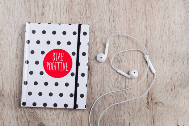 vue de dessus de hotebook avec un casque de couverture et blanc à pois sur table en bois. lay plat minime. - polka dot audio photos et images de collection