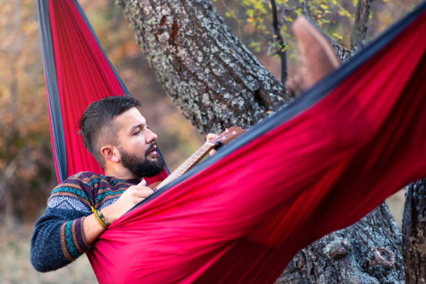istock Man lying in a hammock and relaxing outdoors 1095237042