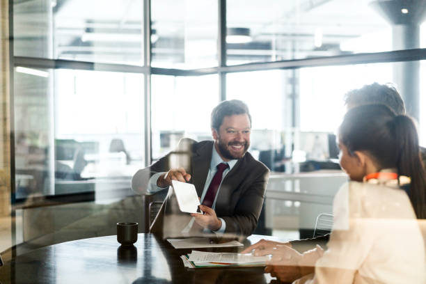 istock Smiling financial advisor showing tablet to couple 1095238724