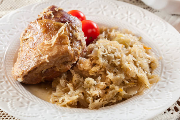 istock Pork knuckle with fried sauerkraut and tomatoes 1095239926