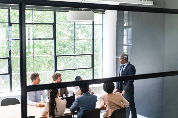 istock Businessman discussing with team in board room 1095240614