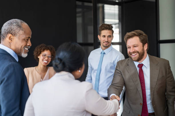 istock Smiling businessman shaking hands with colleague 1095240864
