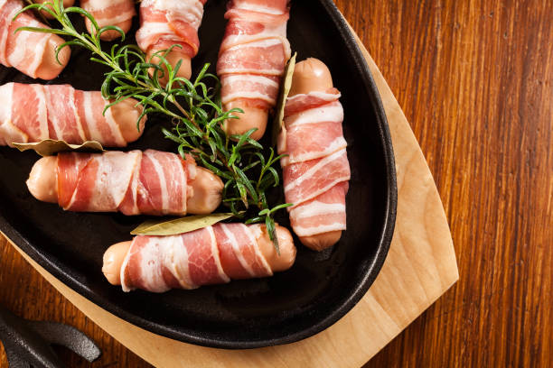 istock Raw mini sausages wrapped in smoked bacon 1095244134