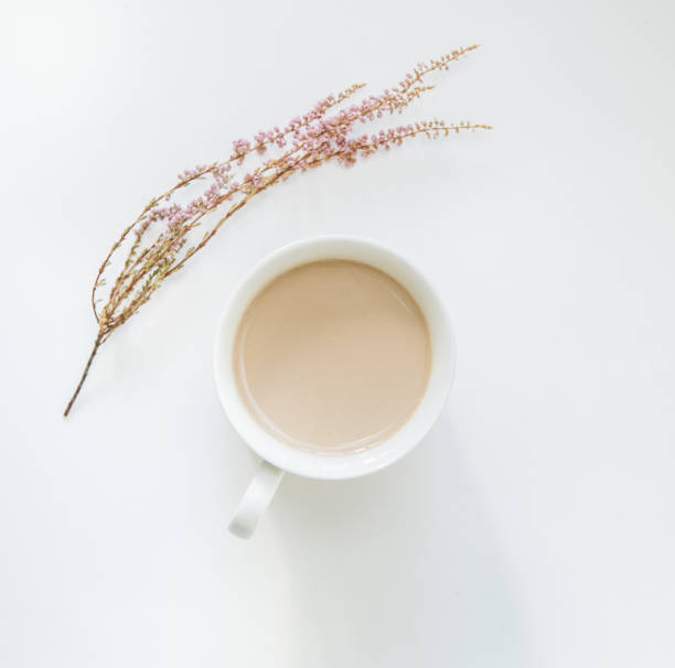 istock cup coffee latte flowers minimalism white isolated 1095245054