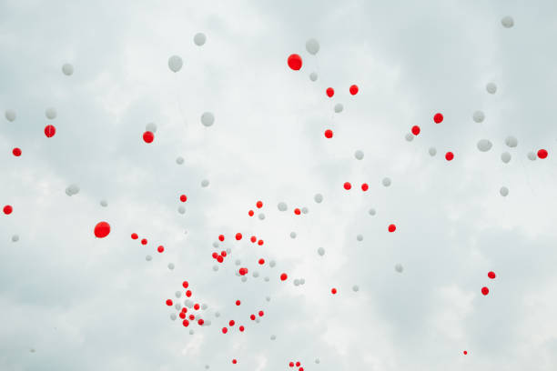 istock lot balloons red white fly sky clouds 1095245066