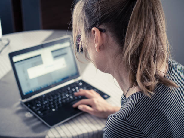 istock Middle-aged woman using laptop at home 1095247544