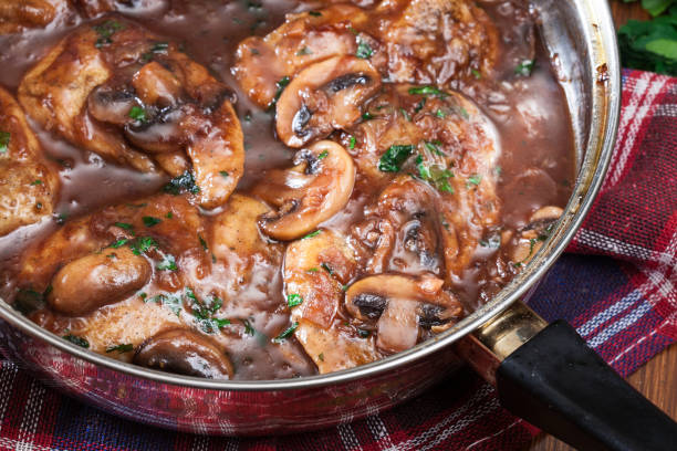 Delicious chicken marsala on frying pan stock photo