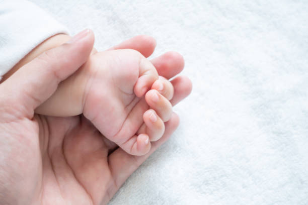istock Mother holding newborn baby hand 1095257644