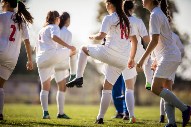 istock Female soccer team warming up before the match on a playing field. 1095259134