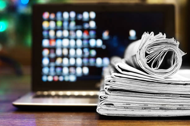 istock Newspapers and Laptop 1095264934