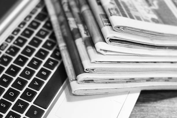 istock Newspapers and Laptop 1095265288