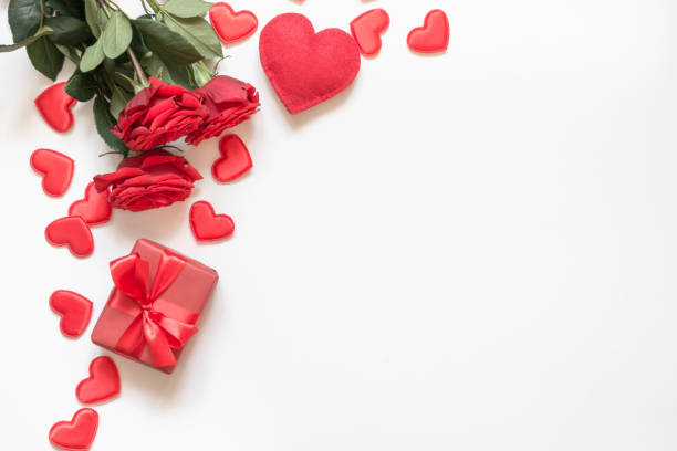 istock Valentine's day greeting card. Composition with gift, roses, red hearts on white. Top view. Copy space. 1095266178