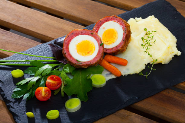 istock Dish scotch egg with tomatoes, mashed potatoes and greens, traditional Scottish cuisine 1095270358