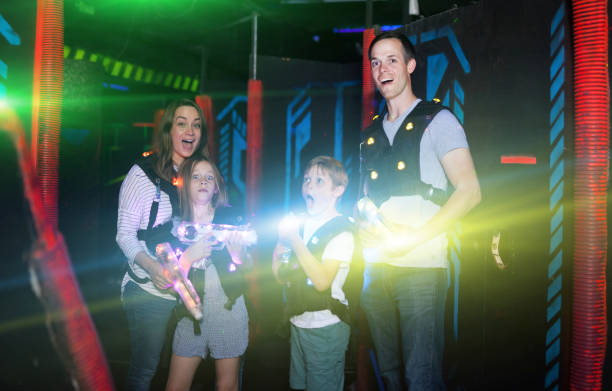 istock Kids and parents in beams during laser tag game 1095277406