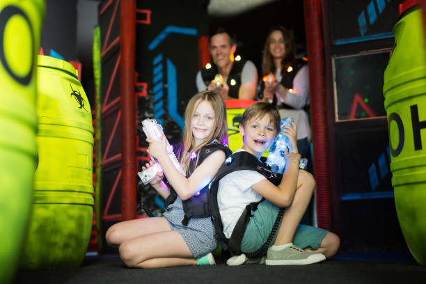 istock Kids sitting back to back with laser guns 1095277426