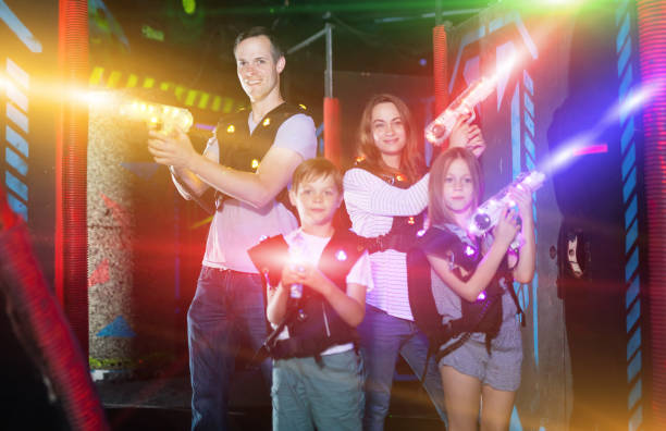 istock Kids and parents in beams during laser tag game 1095277434