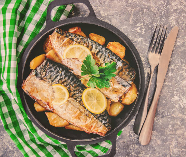 istock baked fish mackerel and potatoes. Selective focus. 1095278838