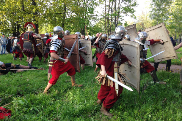 Close up of staged historical reconstruction of the battle of Roman legionnaires at the bottom of museums in the Alexander Park. St. Petersburg, Russia - May 16, 2015: Close up of staged historical reconstruction of the battle of Roman legionnaires at the bottom of museums in the Alexander Park. historical reenactment stock pictures, royalty-free photos & images
