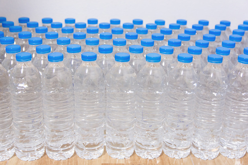 Row of water bottles. Bottles with blue caps For drinking water