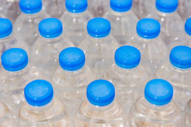 istock Row of water bottles. Bottles with blue caps For drinking water 1095282952