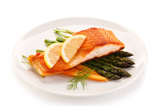 istock Grilled salmon with asparagus on white background 1095283256