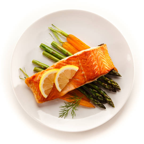 Grilled salmon with asparagus on white background