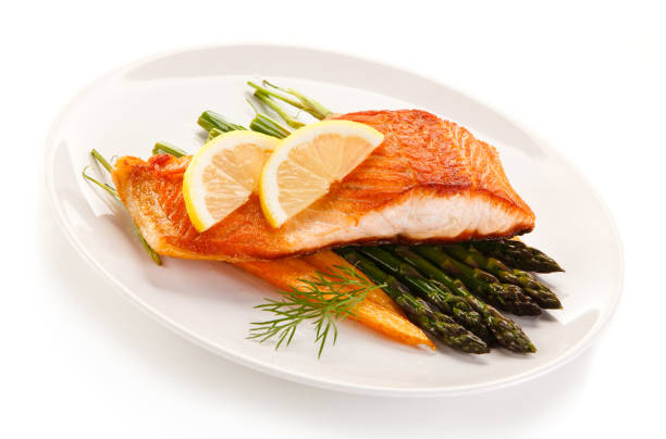 istock Grilled salmon with asparagus on white background 1095283660